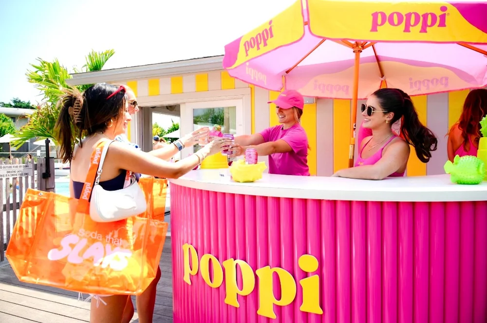 Brand ambassadors serving guests at a branded poolside sampling bar