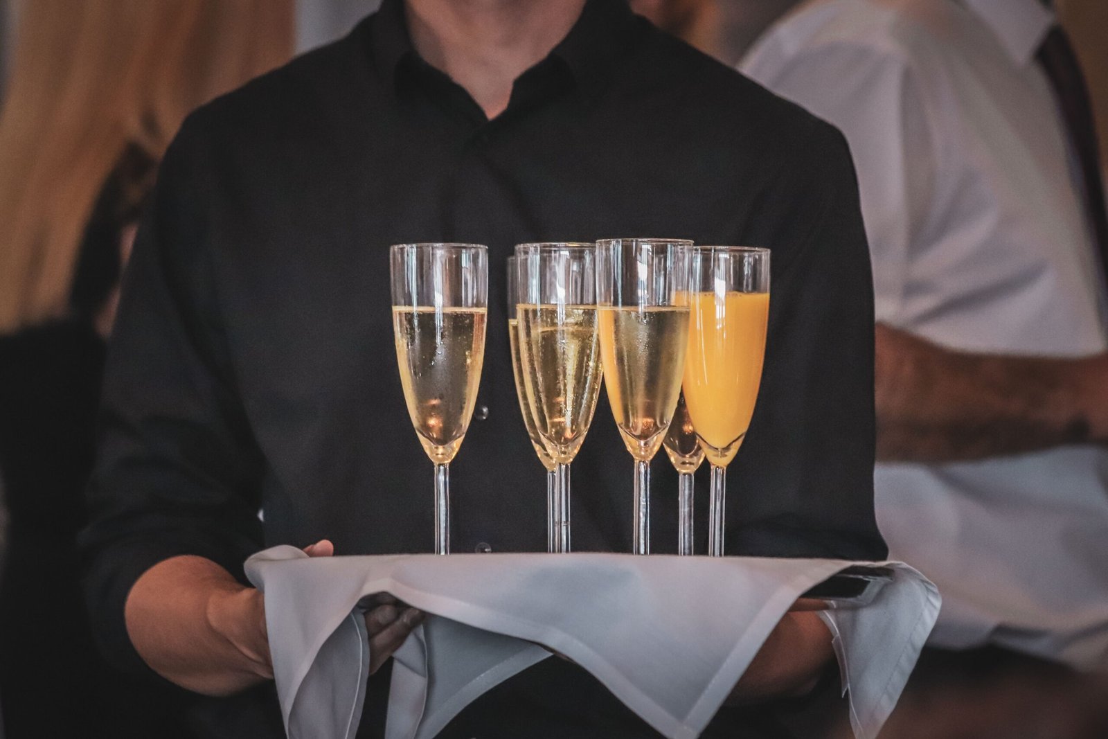 Visage brand ambassadors presenting champagne in a premium event environment